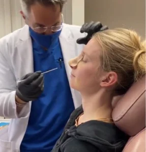 Patient receiving rhinoplasty consultation from Dr. Markarian
