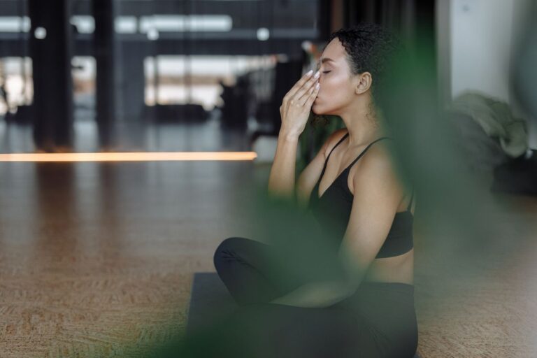 Woman practicing calm, focused breathing indoors