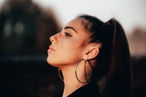 Side profile of a young woman showing a small, softly upturned nose