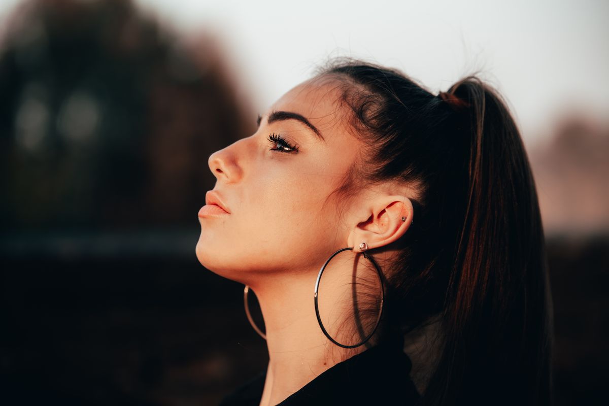 Side profile of a young woman showing a small, softly upturned nose