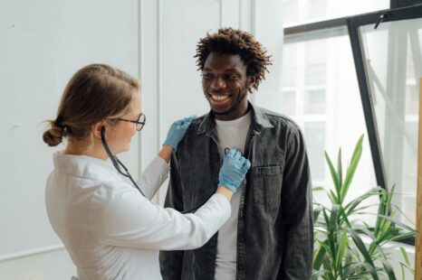 Doctor giving a smiling patient a reassuring follow-up checkup