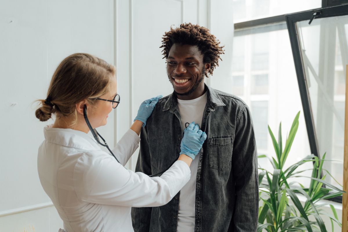 Doctor giving a smiling patient a reassuring follow-up checkup